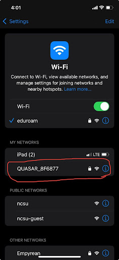 An image of the iPhone WiFi menu, with QUASAR_8F6877 circled in red.